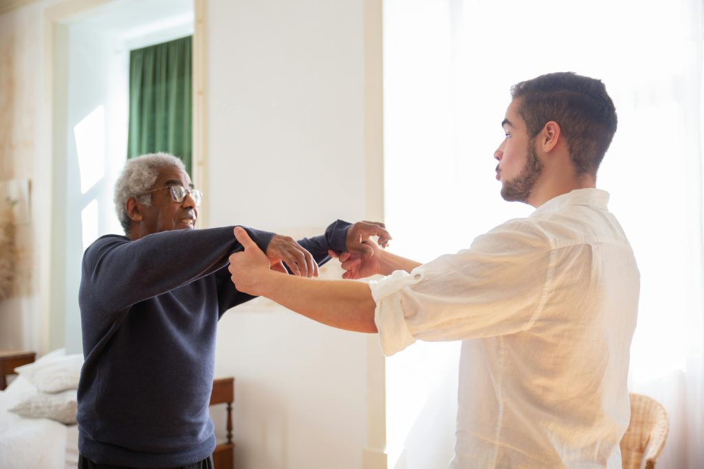 pexels-photo-7551614-7551614 Senior receiving support from caregiver at home, showcasing care and communication.